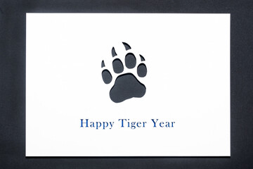 tiger paw silhouette on black background. happy new year black water tiger. 2022 new year card