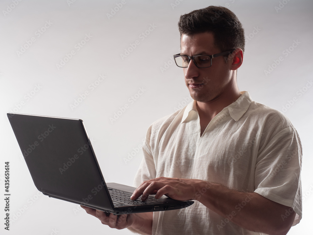 Poster man laptop with glasses. computer master on light background. focused computer master with laptop. c