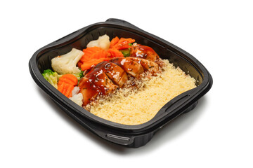 Ready food in a container. Stewed chicken in teriyaki sauce, stewed carrot, cabbage and porridge.