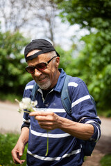 Latino American man in sunglasses likes dandelion