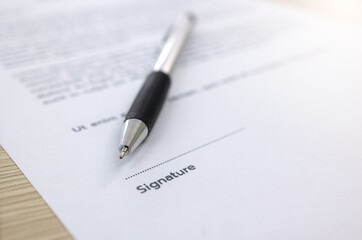 Close up pen is placed on top of the document with a space left for the signature.