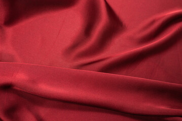 Obraz premium Red silk or satin luxury fabric texture can use as abstract background. Top view.
