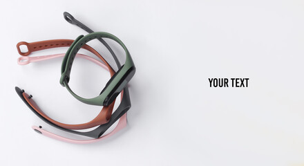 Smart bracelet with interchangeable straps on white background. Modern gadgets. Copy space