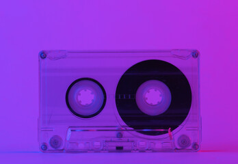 Retro audio cassette in trendy neon light. Gradient pink-blue glow. Concept art. Minimalism