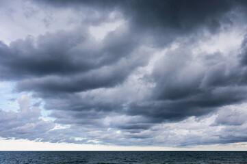 Fototapeta premium Dark dramatic sky and stormy clouds over the sea