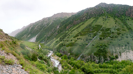 Fototapeta na wymiar Beautiful views of the mountains with snowy peaks in Kyrgyzstan. 