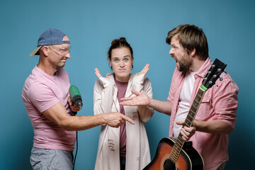 Men accuse each other of excessive noise, one is holding a guitar, the other is a drill, a shocked...