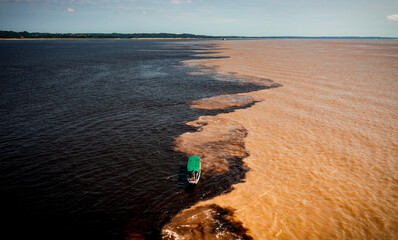 aerial image of the meeting of the Rio Negro and Solimões waters in the Amazon Manaus Brazil - Powered by Adobe