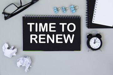 TIME TO RENEW. informationon on a black notebook, on a background office table.