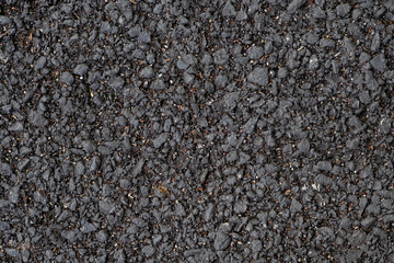 Top view of old and dirty asphalt road, black background