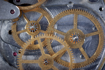 Fototapeta na wymiar Old metal clockwork close-up background. Gears inside an old watch