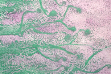 streaks of green paint on paint purple