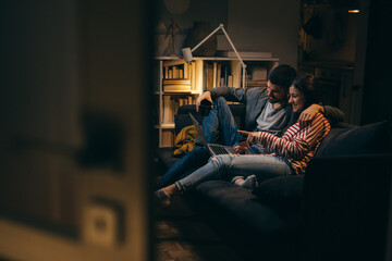 couple enjoying time together at home shopping on line