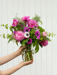 a pink flower arrangement in a vase
