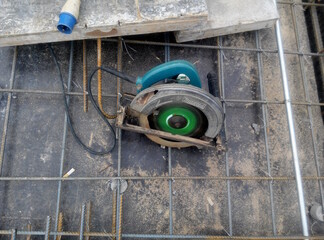 
KUALA LUMPUR, MALAYSIA -JUNE 18, 2020: Mobile circular cutter used by the carpenter to cut plywood at the construction site.  