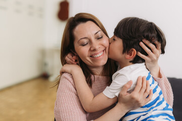 mother and her child kissing and hugging