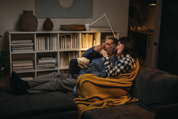 couple enjoying time at home, watching television. evening scene
