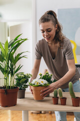 woman gardening houseplants at home