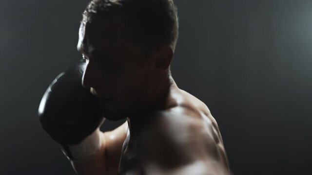 Boxer catching a breath before continuing training with a boxing bag.
