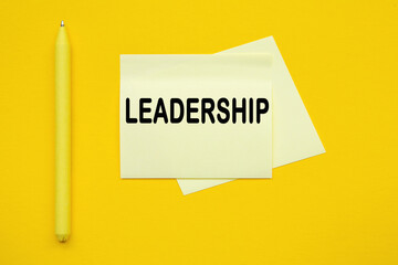 LEADERSHIP . Yellow pen and stickers on a yellow background
