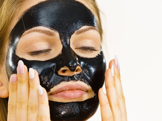 Girl black carbo peel off mask on face