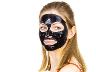 Woman with black peel off mask on face