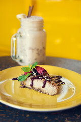 Smoothie and cheesecake with yellow background. Concept of healthy food. Healthy lifestyle and healthy eating concept.