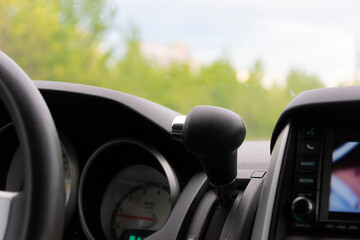 automatic transmission selector on the dashboard of the car in black leather