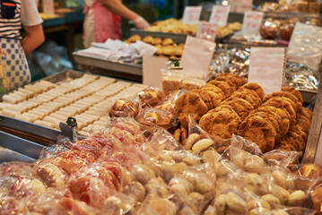 Asian street market. Cookies and pastries at a street food market, Hong Kong. Asian street food at the stall.