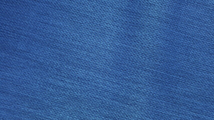 blue woolen fabric texture background. bright blue clothing background. jeans texture with blank space for design.