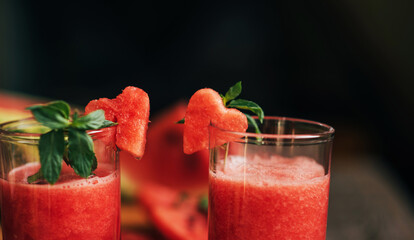 Watermelon on a rustic wooden background. Slices of juicy ripe red watermelon. Fresh juice. Cocktails and soft drinks. Refreshing summer drink.