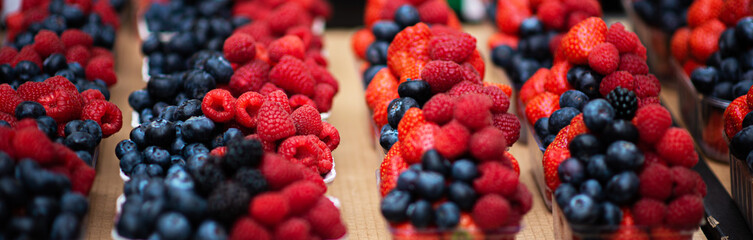 Mix berries includes raspberries, strawberry blackberries and blueberries in the street market. Various colorful berries. Fresh bio fruits, healthy eating, diet, dieting concept, organic food.