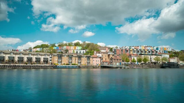 Time lapse of clouds over multi-coloured houses and harbourside in Bristol, UK