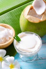 Young coconut pudding served in a glass cup decorated with coconut meat looks delicious on the...