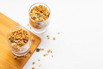 granola in a glass, muesli, healthy breakfast on a white plate