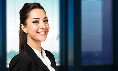 Smiling businesswoman portrait in a modern office