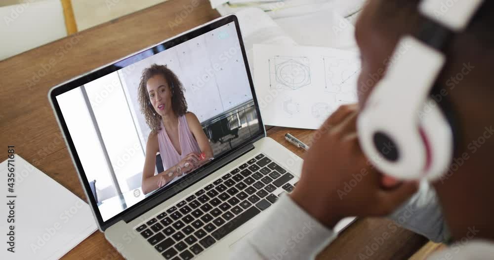 Sticker African american male college student holding notes while having a video call on laptop at home