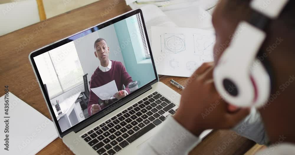 Sticker African american male college student holding notes while having a video call on laptop at home