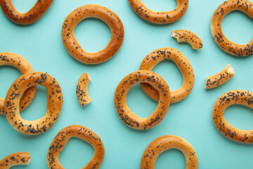Whole bagel with poppy seeds on blue background