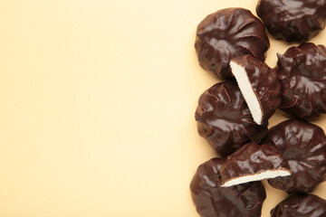 Chocolate covered marshmallows on beige background with copy space. Minimalism