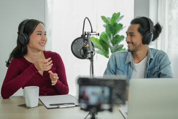 content creator occupation concept. Two influencer record podcast audio in-home office by a...