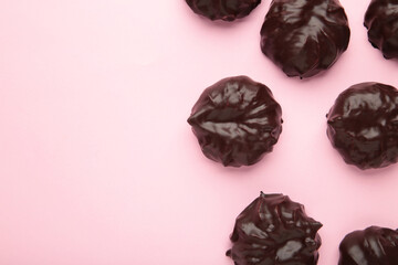 Chocolate covered marshmallows on purple background. Minimalism