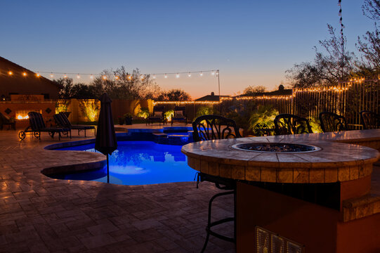 A High Definition View Of A Desert Landscaped Backyard In Mesa Arizona, With A Pool Spa, Outdoor Fireplace And Kitchen.