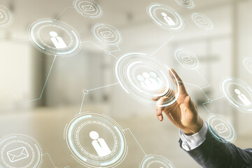 Man hand clicks on abstract virtual social network hologram on blurred office background. Double...