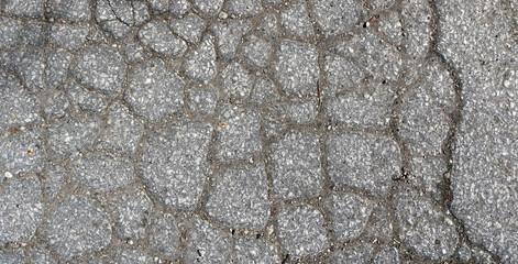 broken and cracked cement surface with irregular shapes and forms - closeup rough texture pattern for a background
