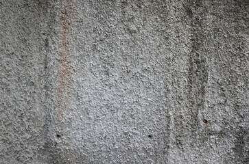 Dirty popcorn ceiling texture of a wall in white color with black grooves - rough surface background