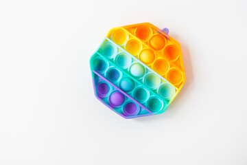 The most fashionable sensory toy. New popular colorful hexagon-shaped pop it anti-stress toy. Toy fidget Rainbow Pop, place for text.