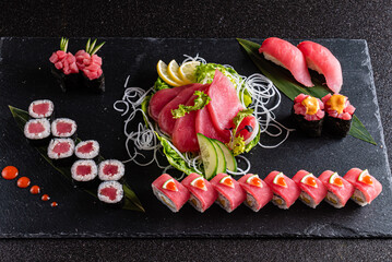 fresh and tasty sushi on the black background