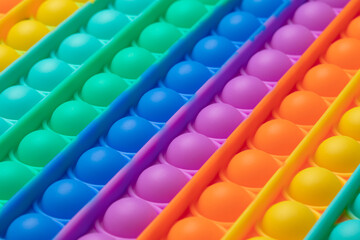 Pop it fidget. Colorful toy push pop it. Close up of antistress sensory fidget - obrazy, fototapety, plakaty