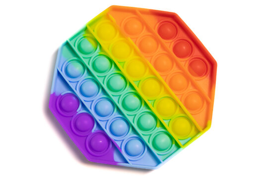 Pop It silicone sensory anti-stress Fidget kid toy colorful rainbow game isolated on white background, copy text space. Calming tools, adult stress reliever popping, trendy push bubble toys
